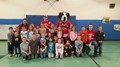 Fighting Saints players and BES students