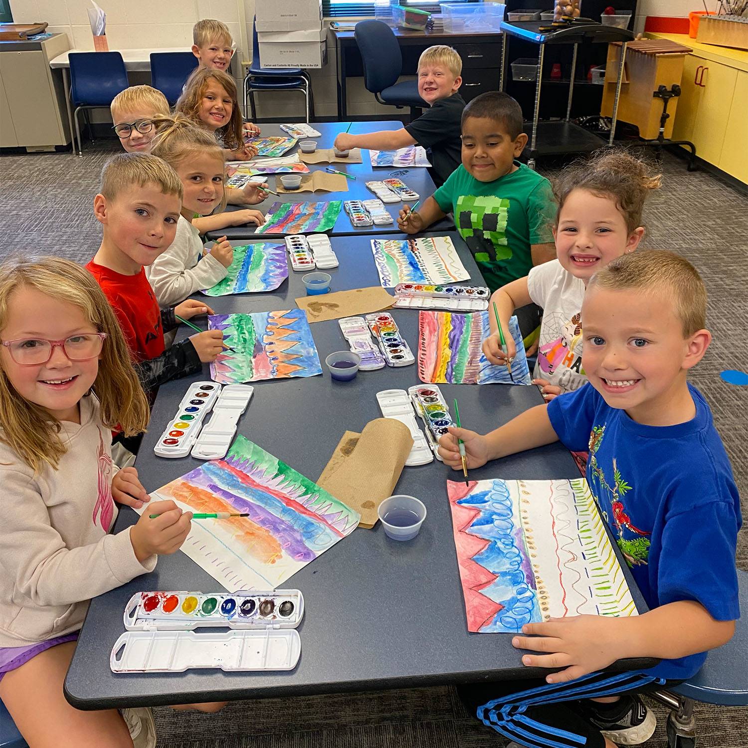 elementary students painting with watercolors