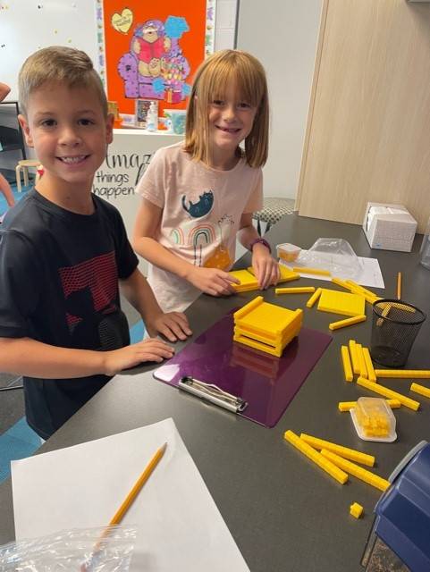 Two 3rd grade students working with math manipulatives.