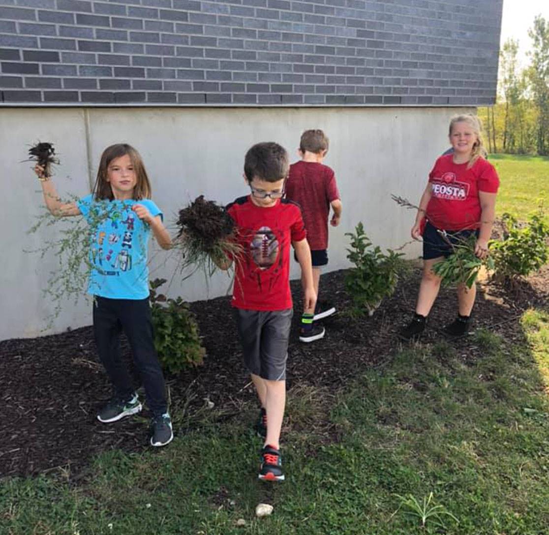 PES - 2nd grade students pulling weeds