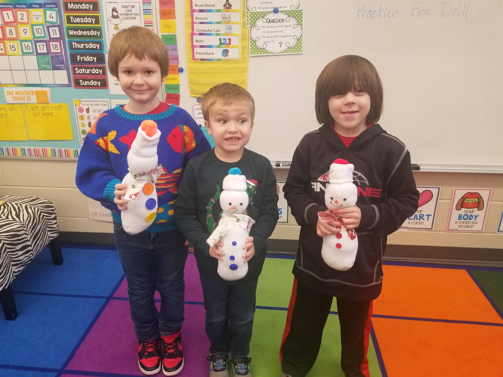 1st graders with the snowmen they created