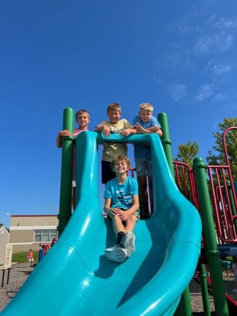 Four 5th Grade boys on slide
