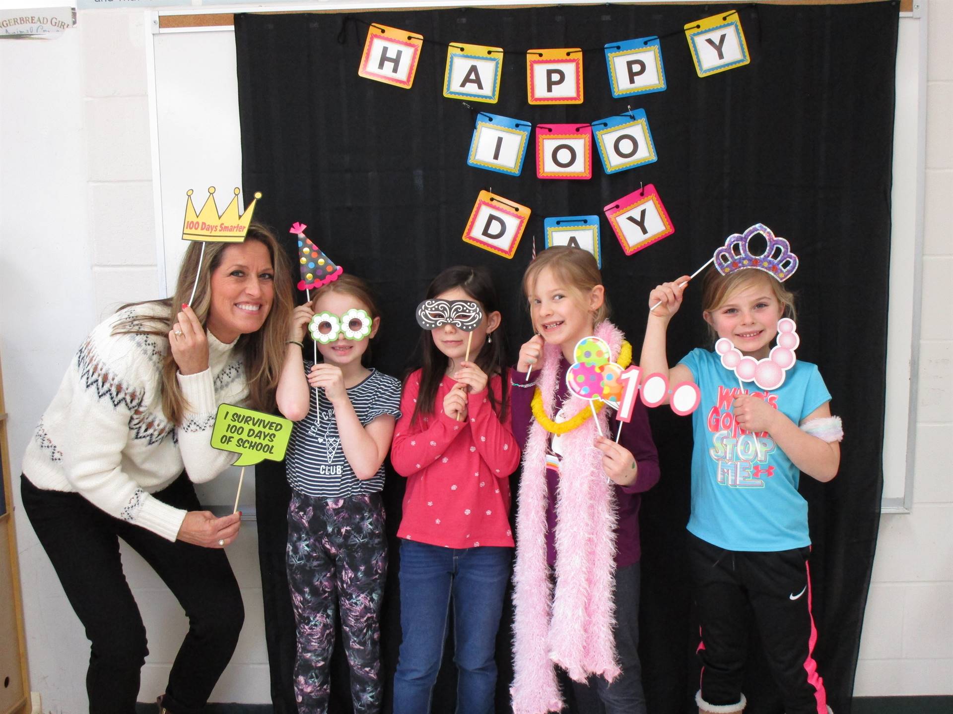 Adult with students on 100th day