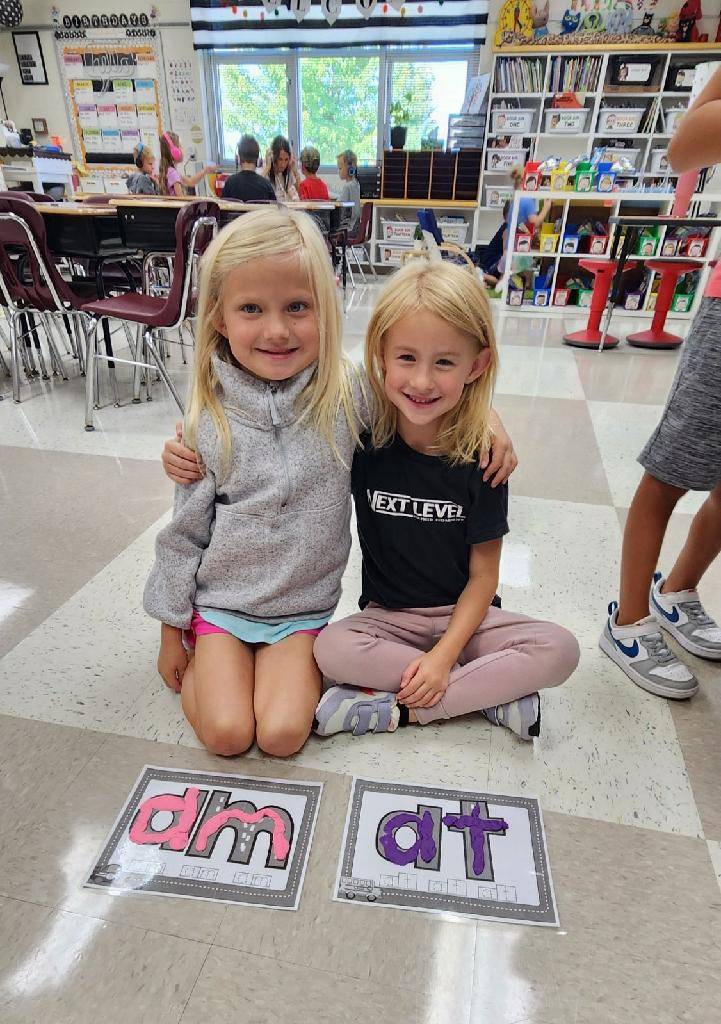 Two first grade students spelling