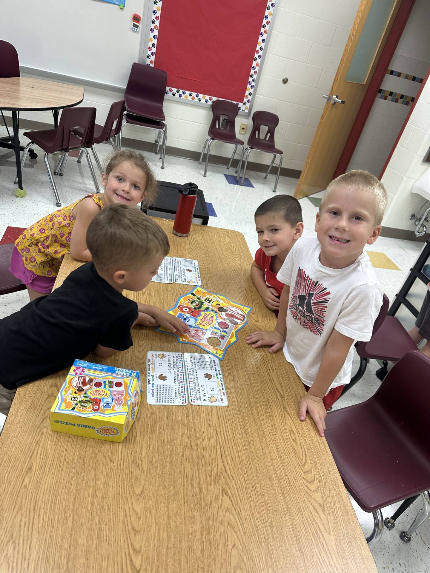 kindergarten students around table playing game